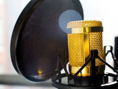Photo by Jean Balzan from Pexels https://www.pexels.com/photo/close-up-photo-of-gold-colored-and-black-condenser-microphone-682082/